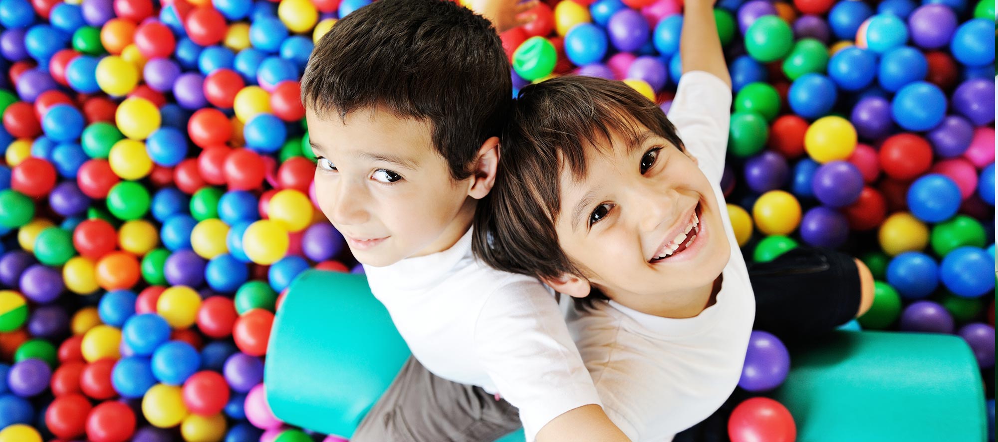 Boys playing in ball pit