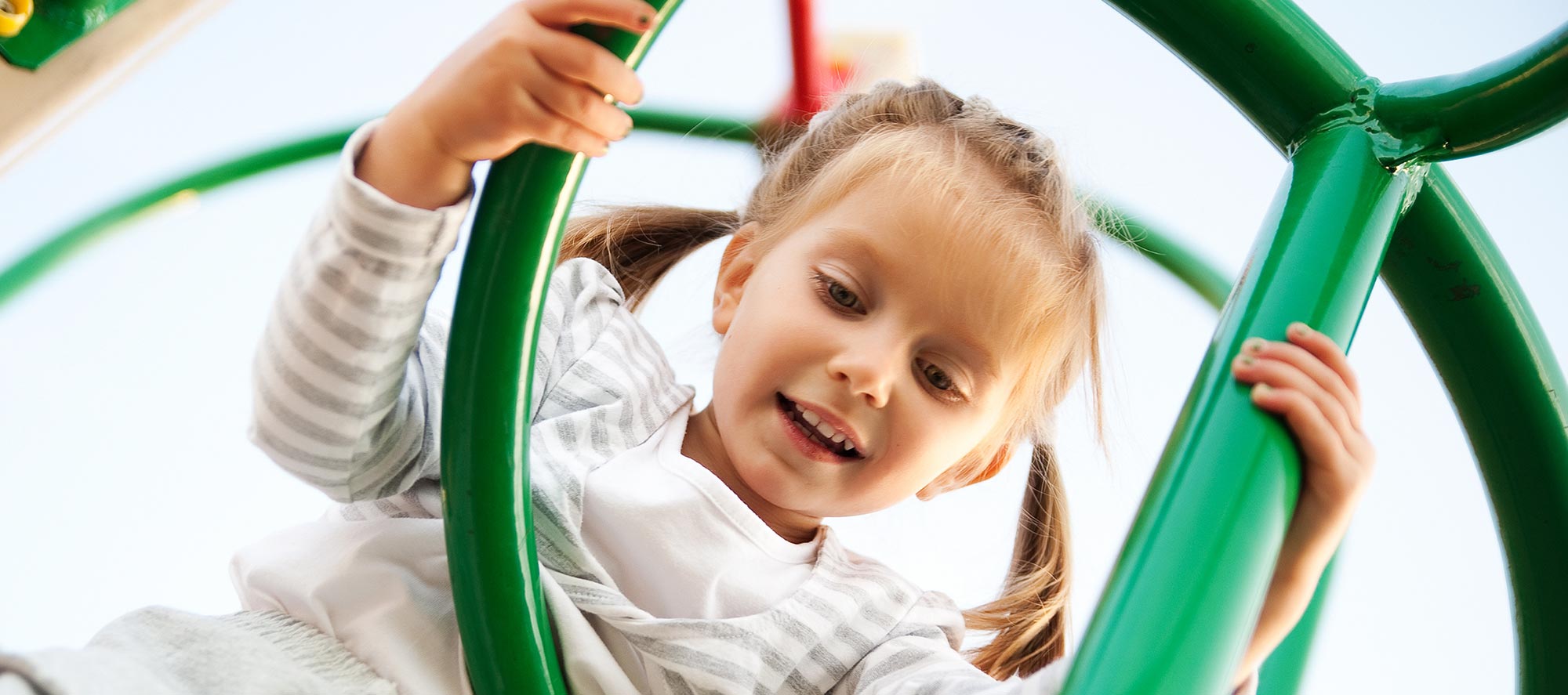 Girl on jungle gym