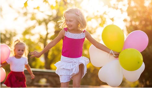Girl running with balloons